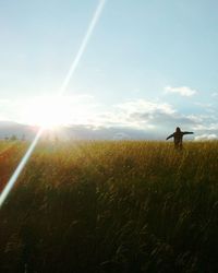 Scenic view of grassy field against sky