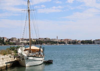 Boat in sea with pula in background 