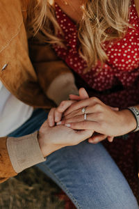 Midsection of couple holding hands