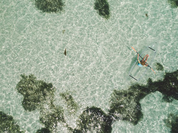 Aerial view of woman kayaking in sea