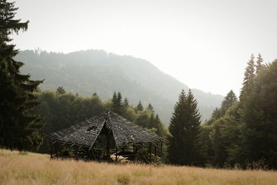 Scenic view of trees and houses against clear sky