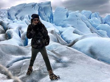 Portrait of woman standing at glacier 