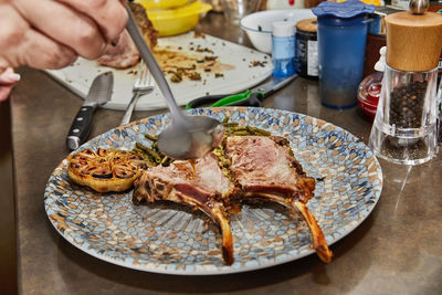 Cropped hand preparing food on table