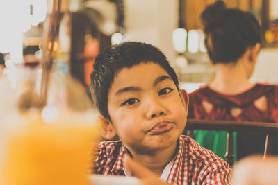 Close-up portrait of boy sitting at restaurant