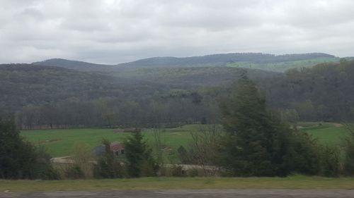 Scenic view of landscape against cloudy sky