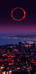 High angle view of city lit up at night