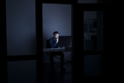 Man sitting on table at home