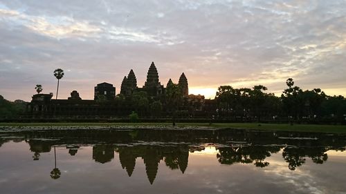 Reflection of temple in lake at sunset