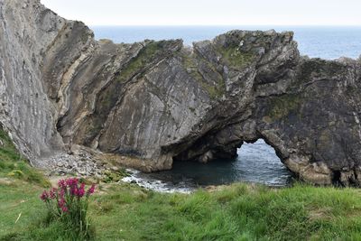 Scenic view of rocks in sea against sky