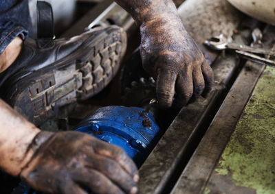 Close-up of man fixing machinery