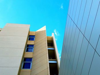 Low angle view of office building against blue sky