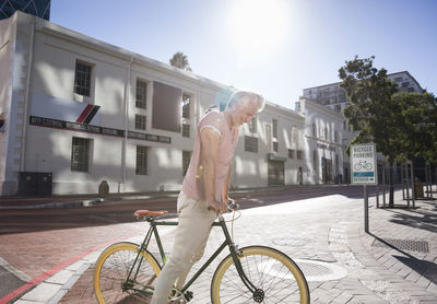 Mature man riding bicycle in the city on the move