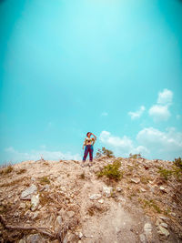 Man standing on field against sky