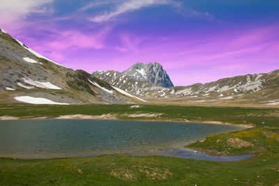 Scenic view of lake and mountains against sky