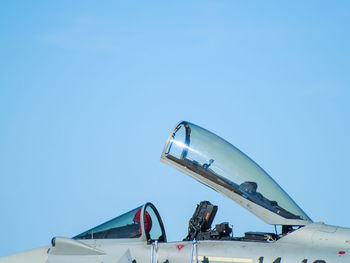 Low angle view of fighter plane against clear blue sky