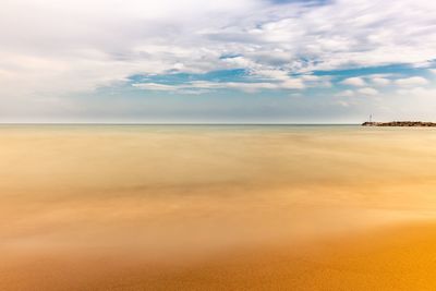 Scenic view of beach against sky during sunset