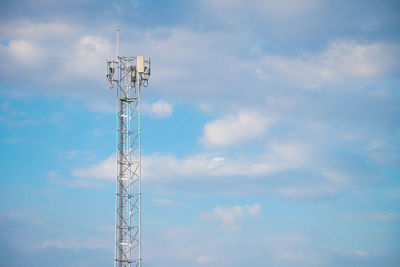 Low angle view of communications tower against sky