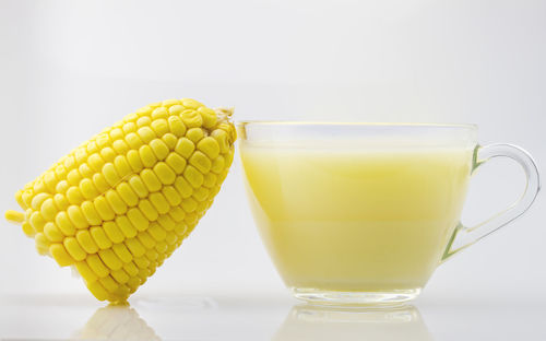 Close-up of yellow drink against white background