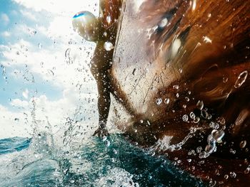 Man splashing water in swimming pool