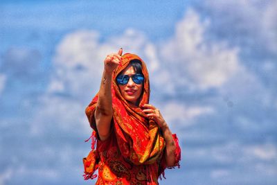 Portrait of woman with sunglasses against sky