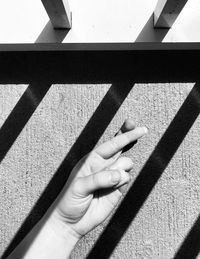 High angle view of person shadow on railing