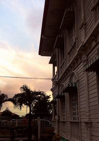 Low angle view of buildings against cloudy sky