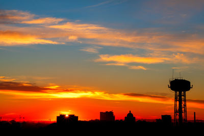 Silhouette buildings against sky during sunset