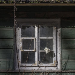 Close-up of rusty window of abandoned building