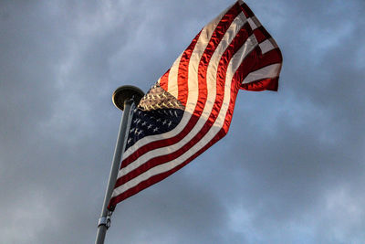 Low angle view of american flag against sky