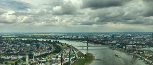 Cityscape against cloudy sky