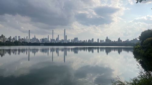 Panoramic view of lake and buildings against sky
