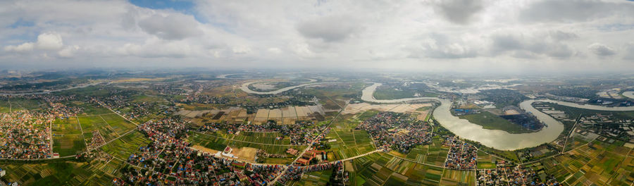 Panoramic shot of agricultural field against sky