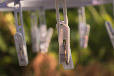 Close-up of clothespins hanging on clothesline