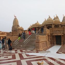 Group of people in temple against clear sky