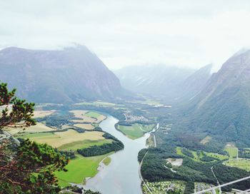 Scenic view of river and mountains against sky