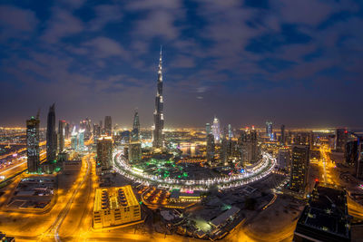 Aerial view of city lit up at night