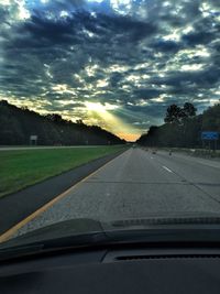 Car on road against sky during sunset