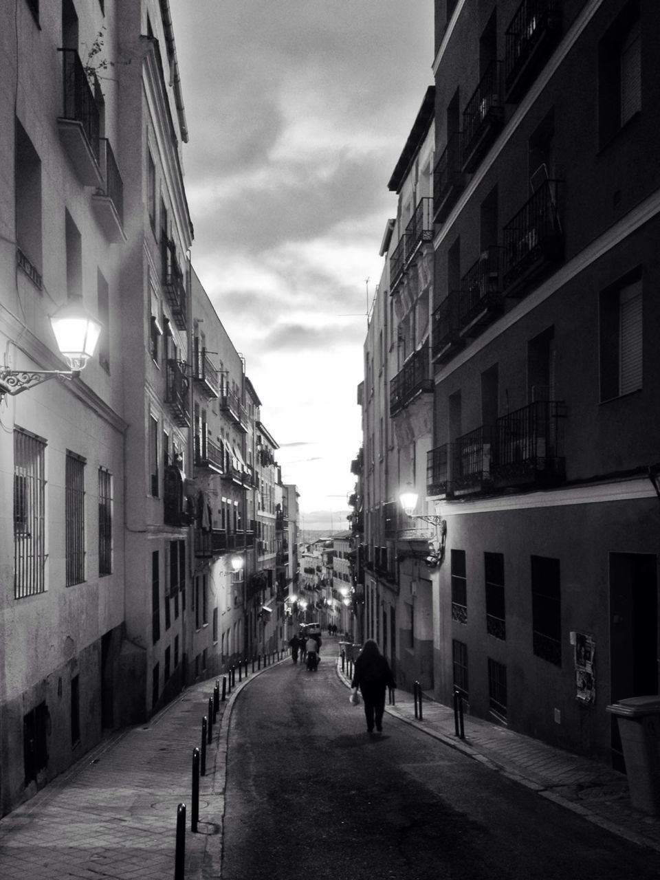 building exterior, architecture, built structure, the way forward, city, street, sky, residential building, building, residential structure, diminishing perspective, walking, city life, incidental people, vanishing point, alley, men, narrow, residential district