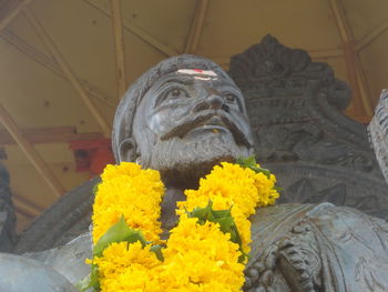 Low angle view of yellow statue