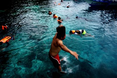 High angle view of men swimming in pool