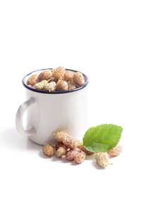 Close-up of ice cream on table against white background