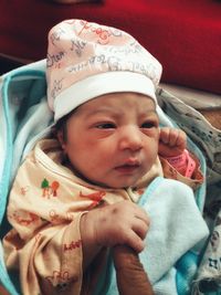 Close-up portrait of cute baby on bed