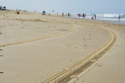 View of tire tracks on beach