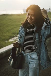 Portrait of smiling young woman standing outdoors