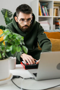 Young man using laptop at table