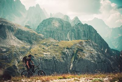 Man with bicycle on mountain