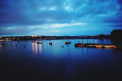 Scenic view of sea against cloudy sky at night