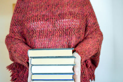 Midsection of woman holding books