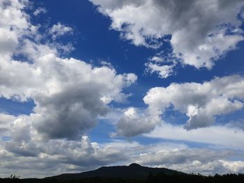 Low angle view of clouds over mountain