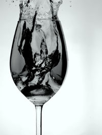 Close-up of wineglass on white background